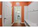 Welcoming entryway with wainscoting, a bench, and a view into another room at 10211 Snowbell Ct, Charlotte, NC 28215