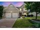 Charming two-story home featuring a manicured lawn, a two-car garage, and stone and siding accents at 10211 Snowbell Ct, Charlotte, NC 28215