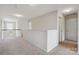 Bright upstairs hallway with neutral carpeting and trim, enhanced by natural light and recessed lighting at 10211 Snowbell Ct, Charlotte, NC 28215