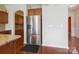 Stylish kitchen featuring a stainless steel refrigerator, granite countertops, and hardwood flooring at 10211 Snowbell Ct, Charlotte, NC 28215