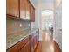 Kitchen cabinets with granite countertops and hardwood flooring at 10211 Snowbell Ct, Charlotte, NC 28215