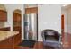 Stylish kitchen featuring a stainless steel refrigerator, granite countertops, and hardwood flooring at 10211 Snowbell Ct, Charlotte, NC 28215