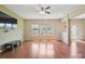 Bright living room featuring hardwood floors, large windows, and a ceiling fan at 10211 Snowbell Ct, Charlotte, NC 28215