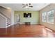 Open-concept living room with hardwood floors, ceiling fan, and natural light at 10211 Snowbell Ct, Charlotte, NC 28215
