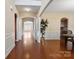 Elegant living room with hardwood floors, arched doorways, and a neutral color palette at 10211 Snowbell Ct, Charlotte, NC 28215
