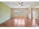 Bright living room featuring hardwood floors, large windows, and a ceiling fan at 10211 Snowbell Ct, Charlotte, NC 28215