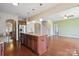 Open-concept living room features hardwood floors, a spacious island, and easy access to the staircase at 10211 Snowbell Ct, Charlotte, NC 28215
