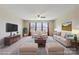 Bright living room features a plush sofa, accent chairs, area rug, and a large window at 10211 Snowbell Ct, Charlotte, NC 28215