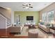 Stylishly staged living room with contemporary furniture, hardwood floors, and large windows for a comfortable living space at 10211 Snowbell Ct, Charlotte, NC 28215