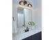 Bathroom vanity featuring a modern mirror, dark fixtures, and stylish decor at 1025 Harrogate Dr, Bessemer City, NC 28016