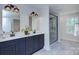 Bathroom features a double vanity with modern lighting and a frameless glass shower at 1025 Harrogate Dr, Bessemer City, NC 28016