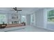 Bright bedroom features a tray ceiling, plush carpeting, and abundant windows at 1025 Harrogate Dr, Bessemer City, NC 28016