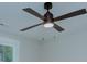 Close-up of a modern ceiling fan with dark blades and integrated lighting at 1025 Harrogate Dr, Bessemer City, NC 28016