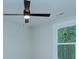 Close-up of a modern ceiling fan with dark blades and integrated lighting near a window at 1025 Harrogate Dr, Bessemer City, NC 28016