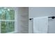 Storage closet with natural light features wire shelves and towel rack at 1025 Harrogate Dr, Bessemer City, NC 28016