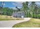Two-story home featuring a covered front porch, driveway and a well-manicured lawn at 1025 Harrogate Dr, Bessemer City, NC 28016