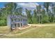 Two-story home featuring a covered front porch and a well-manicured lawn at 1025 Harrogate Dr, Bessemer City, NC 28016