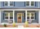 Inviting front porch with neutral furniture, modern door, and exterior lighting at 1025 Harrogate Dr, Bessemer City, NC 28016