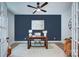 Stylish home office with a dark accent wall, modern decor, and ample workspace, perfect for productivity and comfortable remote work at 1025 Harrogate Dr, Bessemer City, NC 28016