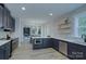 Modern kitchen with stainless steel appliances, dark cabinets, and an island at 1025 Harrogate Dr, Bessemer City, NC 28016