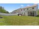 A large, green backyard showcasing a patio, grill, fenced yard, and a screened porch for outdoor enjoyment at 107 Hornbeam Ln, Mooresville, NC 28117