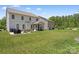 Spacious backyard featuring a patio area with outdoor dining set and a screened in porch at 107 Hornbeam Ln, Mooresville, NC 28117
