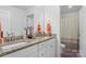 Well-lit bathroom featuring double vanity sinks, granite countertops, and tile flooring at 107 Hornbeam Ln, Mooresville, NC 28117
