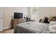 Bright bedroom features woodgrain flooring, a large window, and neutral paint at 107 Hornbeam Ln, Mooresville, NC 28117
