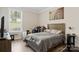 Bright bedroom features woodgrain flooring, a large window, and neutral paint at 107 Hornbeam Ln, Mooresville, NC 28117