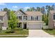 Charming two-story home with attached two-car garage and well-maintained lawn at 107 Hornbeam Ln, Mooresville, NC 28117