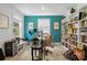Bright home office featuring a built-in bookshelf, natural light, and an accent wall at 107 Hornbeam Ln, Mooresville, NC 28117