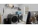 Modern laundry room with front loading washer and dryer, shelving, and ample counter space at 107 Hornbeam Ln, Mooresville, NC 28117