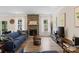 Bright living room featuring stone fireplace, natural light, and wood grain tile at 107 Hornbeam Ln, Mooresville, NC 28117