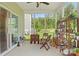 Screened patio with wooden furniture, offering a cozy outdoor living space at 107 Hornbeam Ln, Mooresville, NC 28117