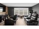 Dark theater room with black leather reclining chairs and window with blinds at 107 Hornbeam Ln, Mooresville, NC 28117