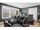 Dark theater room with black leather reclining chairs and window with blinds at 107 Hornbeam Ln, Mooresville, NC 28117