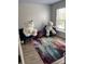 Cozy bedroom featuring unique decor including two large teddy bears and colorful rug at 10826 Claude Freeman Dr, Charlotte, NC 28262