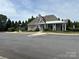 A well-maintained clubhouse with ample parking and green surroundings at 10826 Claude Freeman Dr, Charlotte, NC 28262