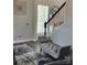 Inviting entryway featuring elegant staircase, stylish accent bench, and tasteful decor at 10826 Claude Freeman Dr, Charlotte, NC 28262