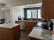 Well-lit kitchen featuring granite counters, stainless appliances, and a stylish chandelier above the eating area at 10826 Claude Freeman Dr, Charlotte, NC 28262