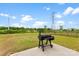 Backyard featuring a grill on a concrete patio, perfect for outdoor cooking at 11518 Solstice Way, Huntersville, NC 28078