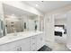 Modern bathroom with double vanity, large mirror, sleek tile, and glass-enclosed shower at 11518 Solstice Way, Huntersville, NC 28078
