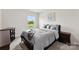 Cozy bedroom with comfortable bed, neutral tones, and scenic backyard views at 11518 Solstice Way, Huntersville, NC 28078