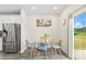 Bright dining area with glass table, modern chairs, and a sliding glass door at 11518 Solstice Way, Huntersville, NC 28078