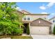 Charming two-story home featuring a mix of brick and siding, complemented by a well-manicured lawn and mature landscaping at 11518 Solstice Way, Huntersville, NC 28078