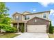 Well-maintained two-story home showcasing brick and siding, an attached garage, and a neatly kept lawn and landscaping at 11518 Solstice Way, Huntersville, NC 28078
