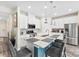 Modern kitchen features stainless steel appliances, white cabinets, and an island with bar seating at 11518 Solstice Way, Huntersville, NC 28078