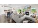Bright, open living area flowing into kitchen, featuring modern fireplace, neutral decor, and sliding glass doors at 11518 Solstice Way, Huntersville, NC 28078