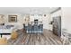 Open-concept living area with an island and seating, flowing into kitchen, enhancing the home's modern appeal at 11518 Solstice Way, Huntersville, NC 28078