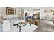 Spacious living area featuring a sofa, island with stools, and modern decor, creating a seamless and stylish design at 11518 Solstice Way, Huntersville, NC 28078